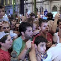 A policeman tries to control migrants as ticket control rules now mandate each passenger to have allocated seats on trains bound for the West from Budapest on Monday. Austrian authorities toughened controls along the country’s eastern borders on Monday, stopping hundreds of refugees and arresting five traffickers in a clampdown that followed last week’s gruesome discovery of 71 dead migrants in a truck. In abrupt U-turn, Hungary closes westbound trains to refugees; traffickers poised to pounce