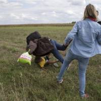 This composite photo shows camerawoman Petra Laszlo tripping a migrant who was carrying a child while they were trying to escape from a collection point in Roszke village, Hungary, on Tuesday. Laszlo was fired later that day after videos of her kicking and tripping up migrants fleeing police, including a man carrying a child, spread in the media and on the web. | REUTERS