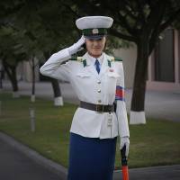 A North Korean traffic police woman salutes Sept. 15 as vehicles are driven past her at an intersection in Pyongyang. A U.S.-based institute has said the North will probably not launch a long-range missile to mark its October anniversary. Launch of long-range rocket unlikely at North Korea anniversary but nuke test site activity seen: institute
