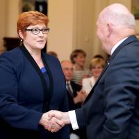 Marise Payne, Australia\'s new defense minister, shakes hands with Governor-General Peter Cosgrove during a swearing-in ceremony at Government House in Canberra on Monday. | REUTERS