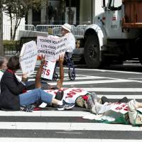 Protesters block a street outside Saint Matthew\'s Cathedral in Washington during Pope Francis\' prayer meeting with U.S. bishops Wednesday. | REUTERS