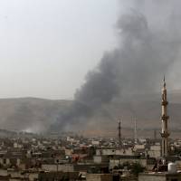 Smoke rises from what activists said was a military position of forces loyal to Syria\'s President Bashar Assad after clashes with Army of Islam fighters, on the eastern mountains of Qalamoun overlooking the town of Douma, eastern Ghouta of Damascus Sunday. Reports the same day indicated Russia may be willing to see key ally Assad sidelined to resolve the Syria situation and to maintain a Moscow leverage in the Mideast. | REUTERS