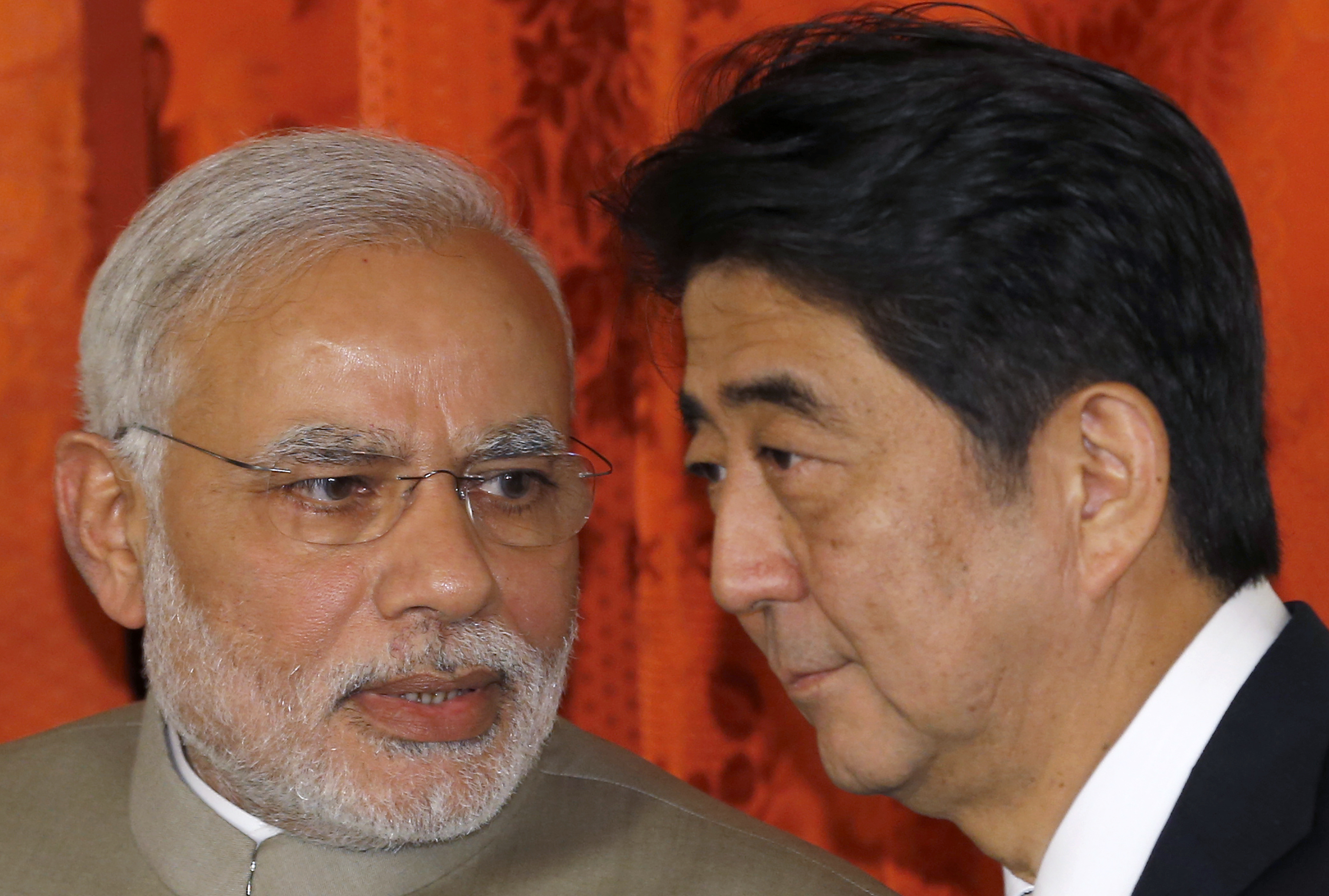 Indian Prime Minister Narendra Modi speaks to Prime Minister Shinzo Abe after their meeting in Tokyo in September 2014. Abe received a birthday message from Modi on Twitter on Monday but sent a reply to the wrong person. | BLOOMBERG