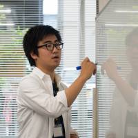 A university student teaches class at the Tadazemi free cram school for junior high school students in Tokyo. | BLOOMBERG