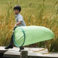Prince Hisahito, the only son of Prince Akishino and Princess Kiko and third in line to the Imperial throne, holds a net on the grounds of Akasaka Palace in Tokyo on Aug. 16. He turned 9 on Sunday. | REUTERS