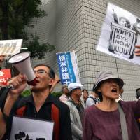 People protest against Prime Minister Shinzo Abe’s controversial security bills, outside of the venue of a public hearing in Yokohama on Wednesday. Japan is set to enact controversial security bills that opponents say will undermine 70 years of pacifism. Protesters rally as contentious security bills near passage