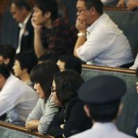 Visitors in the Upper House gallery watch lawmakers vote on a no-confidence motion filed by the opposition against the body’s president, Masaaki Yamazaki, during a plenary session Friday. Ruling bloc on verge of enacting security laws