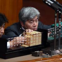 Clerks count ballots in a censure resolution against Upper House President Masaaki Yamazaki, which took place as the government attempted to pass two contentious security bills Friday. | AFP-JIJI