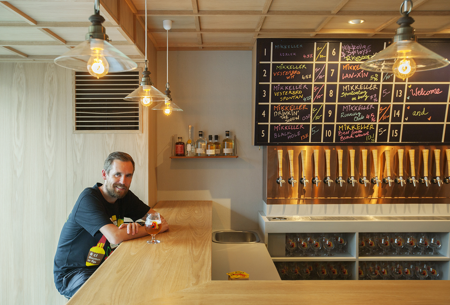 Beer magician: Mikkel Borg Bjergso, who runs Danish microbrewery Mikkeller, sits at the counter to his newest bar, which opened in August along a backstreet of Tokyo's Shibuya district. | SATOSHI NAGARE
