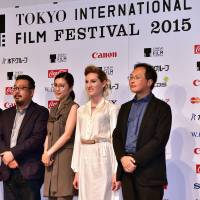 Japanese film directors Kohei Oguri (left), Yoshihiro Nakamura and Koji Fukuda pose for a photo with Japanese actress Yuko Takeuchi (center) and U.S. actress Bryerly Long during a press conference in Tokyo on Tuesday. They will all participate in the competition section of the Tokyo International Film Festival (TIFF). | AFP-JIJI