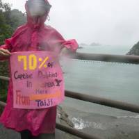 Hwang Hyun-jin, founder of Hot Pink Dolphins, poses for a photo near the place known by some as \"Killer Cove\" in Taiji on Sept. 9. | ROB GILHOOLY