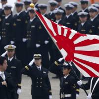The once-over: Prime Minister Shinzo Abe reviews members of the Self-Defense Forces at Hyakuri air base in Omitama, Ibaraki Prefecture. | REUTERS