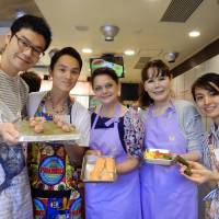 Reko Dida (center), the wife of the Albanian Ambassador, and Honorary Consul of the Republic of Albania Kyoko Spector (second from right) pose with students during a lesson on traditional Albanian cuisine at Hattori Nutrition College in Tokyo on Sept. 5. | MAKI YAMAMOTO-ARAKAWA
