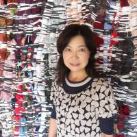 Above: Tomoko Tano, executive director of the Heart Art Link NPO, which organized the Art Bridge Project on Shiraishi Island, stands in front of a work by Kotaro Nagira. Right: Naoto Shimizu recreated the Seto Inland Sea in the floor of a traditional house. | AMY CHAVEZ