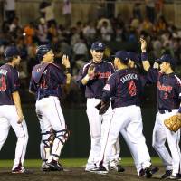 The Swallows celebrate after their win over the Giants on Wednesday. | KYODO