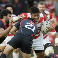Japan\'s Amanaki Lelei Mafi tries to break through the Georgia defense during a Rugby World Cup warmup match on Saturday in Gloucester, England. | KYODO