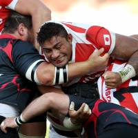 Amanaki Lelei Mafi (center) will try to help change the world\'s perception of Japan during the upcoming Rugby World Cup. | AP