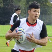 Japan’s Akihito Yamada handles the ball during practice on Tuesday in Bristol, England. | KYODO