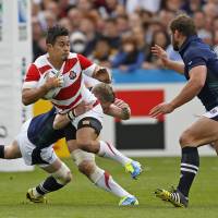 Japan\'s Yu Tamura tries to break through the Scotland defense during their Rugby World Cup match last week. | REUTERS