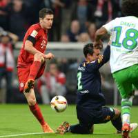 Bayern Munich’s Robert Lewandowski scores his third goal in Tuesday’s 5-1 win over Wolfsburg. Lewandowski scores five in nine minutes