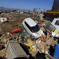 Tsunami debris lies along the coast in Coquimbo, Chile, on Thursday as residents tried to recover what they could from destroyed homes. The waves were triggered by Wednesday\'s magnitude-8.3 earthquake. | REUTERS