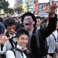 Early evening of the living dead:  Halloween revelry peaked Saturday night in Japan and the area around Shibuya Station, in particular, saw a massive convergence of people decked out in a variety of costumes. | YOSHIAKI MIURA