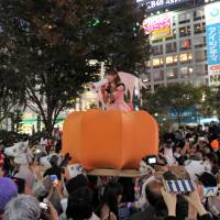 The great pumpkin float: Halloween revelry peaked Saturday night in Japan and the area around Shibuya Station, in particular, saw a massive convergence of people decked out in a variety of costumes. | YOSHIAKI MIURA