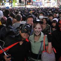 Heroes, villains and cats, just for one day: Halloween revelry peaked Saturday night in Japan and the area around Shibuya Station, in particular, saw a massive convergence of people decked out in a variety of costumes. | YOSHIAKI MIURA