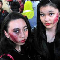 Fresh scar issue: Halloween revelry peaked Saturday night in Japan and the area around Shibuya Station, in particular, saw a massive convergence of people decked out in a variety of costumes. | YOSHIAKI MIURA