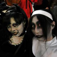 Sister act: The stuff of nightmares: Halloween revelry peaked Saturday night in Japan and the area around Shibuya Station, in particular, saw a massive convergence of people decked out in a variety of costumes. | YOSHIAKI MIURA