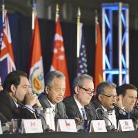 Trade minister Akira Amari (third from left) and his counterparts from other TPP nations hold a news conference after reaching agreement on the Trans-Pacific Partnership in Atlanta on Monday. Abe hails TPP success but calls it 'just a start'