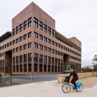 A man rides his bike Monday by the European Court of Justice in Luxembourg. Europe\'s highest court has ruled in favor of an Austrian law student who claims a trans-Atlantic data protection agreement doesn\'t adequately protect consumers. | AP