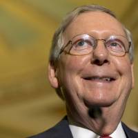 Senate Majority Leader Mitch McConnell smiles while speaking to the media with members of the Republican leadership Tuesday on Capitol Hill in Washington. | AP