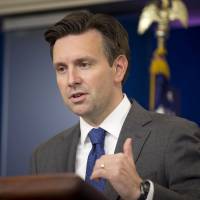 White House press secretary Josh Earnest answers questions during the daily briefing in the Brady Press Briefing Room of the White House in Washington, Monday. The U.S. and 11 other Pacific Rim countries have agreed to the Trans-Pacific Partnership, an ambitious and controversial trade pact that cuts trade barriers, sets labor and environmental standards and protects multinational corporations\' intellectual property. | AP
