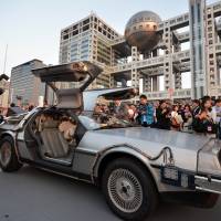 A \"Back to the Future\"-style DeLorean, powered by methanol bio-fuel made from recycled clothing produced by a Japanese venture, is displayed at a shopping complex in Tokyo\'s Odaiba area Wednesday, the 30th anniversary of the movie. | AFP-JIJI