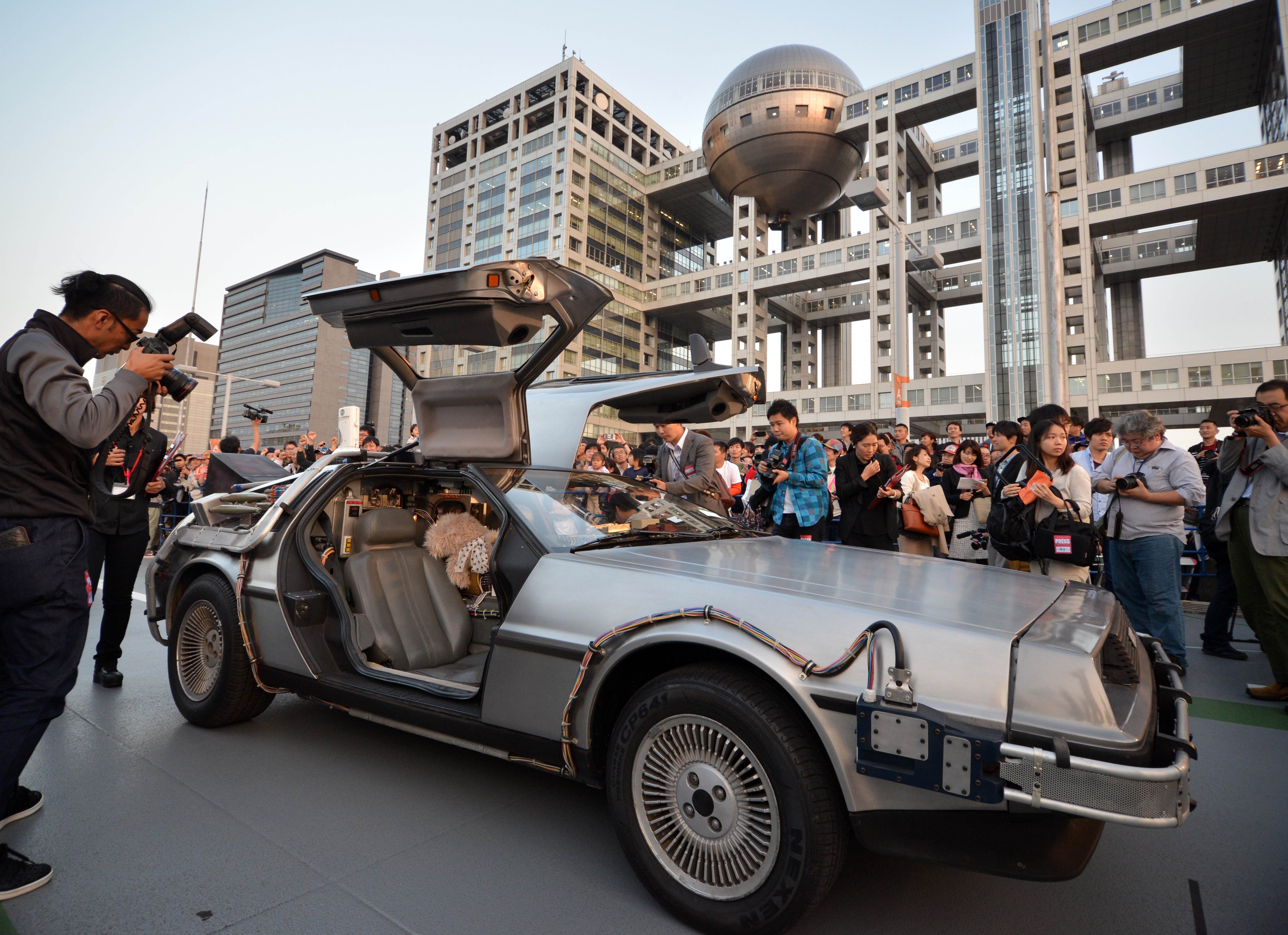 A 'Back to the Future'-style DeLorean, powered by methanol bio-fuel made from recycled clothing produced by a Japanese venture, is displayed at a shopping complex in Tokyo's Odaiba area Wednesday, the 30th anniversary of the movie. | AFP-JIJI