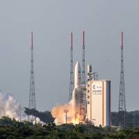 The Ariane 5 rocket launches from Ariane Launch Area 3 at the European spaceport in Kourou, French Guiana, on Wednesday. The rocket successfully launched a pair of communications satellites, the ARSAT-2 satellite for Argentine operator ARSAT and the Muster Sky satellite for Australian operator NBN. | AFP-JIJI