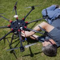 Mike Ferguson, chief pilot at AeroCine, prepares a DJI S1000 drone for flight in Calvert Vaux Park in Brooklyn, New York, in June. | BLOOMBERG