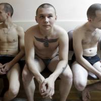 Russian conscripts wait for medical tests at a recruiting station in the southern Russian city of Stavropol on Tuesday. | REUTERS