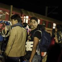 Migrants and refugees wait to board a train near the registration camp, after crossing the Greek-Macedonian border, near Gevgelija on Thursday. Macedonia is a key transit country in the Balkans migration route into the EU, with thousands of asylum seekers and migrants — many of them from Syria, Afghanistan, Iraq and Somalia — entering the country every day, many trying to get to Germany. | AFP-JIJI