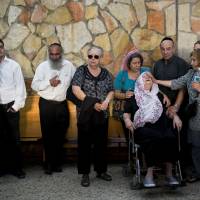 Iza Gobberg (right) reacts during the funeral of her son, Alon, Jerusalem Wednesday. Gobberg was killed on Tuesday when a pair of Palestinian men boarded a bus in Jerusalem and began shooting and stabbing passengers, Two Israelis and two attackers were killed. | AP