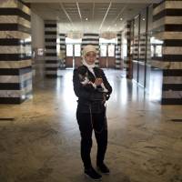 Farah Alkuled, 18, who came with her parents from Daraya, Syria, waits to board a train for Germany in Celje, Slovenia. German Chancellor Angela Merkel has seen her ratings fall over her open-door policy toward refugees like Alkuled. | AP