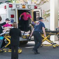 A patient is wheeled into the emergency room at Mercy Medical Center in Roseburg, Oregon, following a deadly shooting at Umpqua Community College, in Roseburg Thursday. | AARON YOST / ROSEBURG NEWS-REVIEW VIA AP