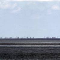 Ongoing land reclamation by China at Subi Reef is seen from Pagasa Island, one of the islets in the South China Sea\'s Spratlys group, in May. | REUTERS