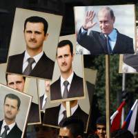 Several hundred people, many holding up portraits of Syrian President Bashar Assad and Russian President Vladimir Putin, gather near the Russian Embassy in Damascus on Tuesday in an expression of support for Moscow\'s air war in Syria. | AFP-JIJI