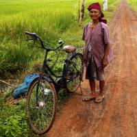 A farmer poses in a rice field in a village near Udon Thani, Thailand, on Sept. 15, 2015. | REUTERS