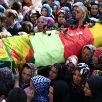 Women carry a coffin in Istanbul on Monday during the funeral service for one of victims of Saturday\'s bomb attack in Ankara. The twin explosions Saturday ripped through a crowd of activists in the capital, leaving at least 97 people dead. | AP