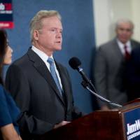 Jim Webb, former Senator from Virginia and former 2016 Democratic presidential candidate, speaks during a news conference with his wife, Hong Le Webb, at the National Press Club in Washington, D.C. Tuesday. Webb said he won’t seek the Democratic presidential nomination. Slamming money politics and out-of-touch parties, Webb exits Democratic campaign