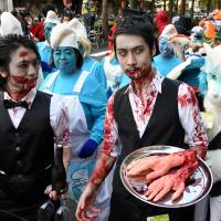 Need a hand with that? Zombie service at the annual Kawasaki Halloween Parade, which attracted about 2,500 participants on Sunday.  | SATOKO KAWASAKI