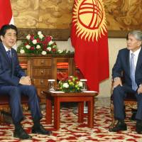 Prime Minister Shinzo Abe and Kyrgyz President Almazbek Atambayev hold talks in the Kyrgyz capital Bishkek on Monday. | KYODO